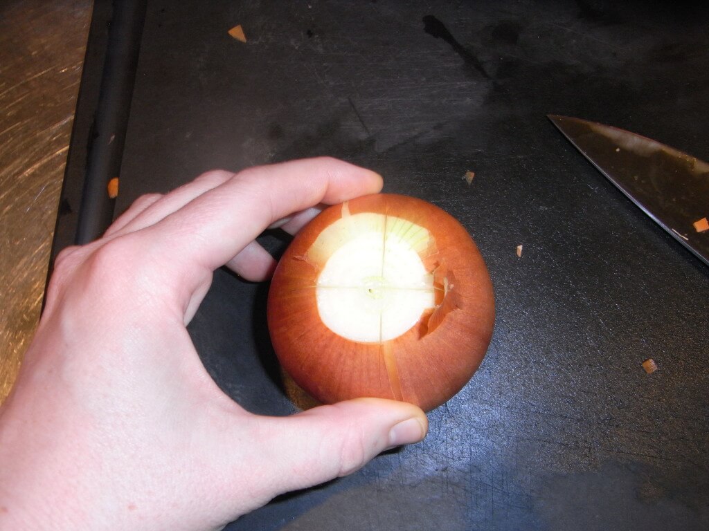Criss cross on the onion, to help peel it