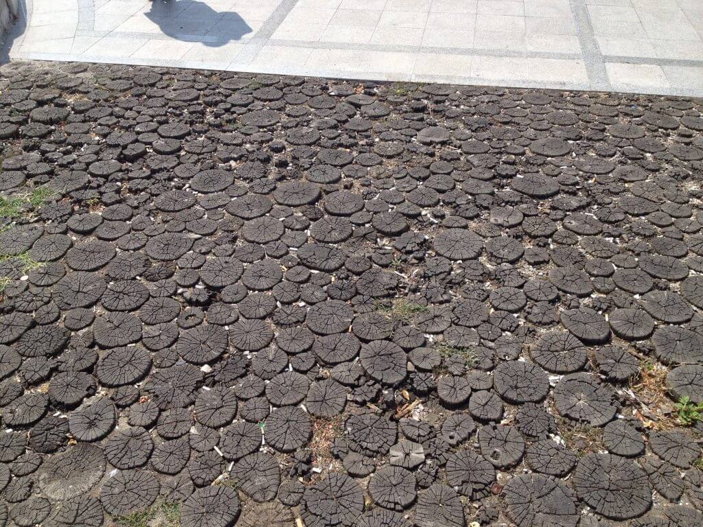 At the base of the communism statue at the top of the post, is a cross in the ground made of these wodden circles - small representing the children and large the adults who died in the revolution